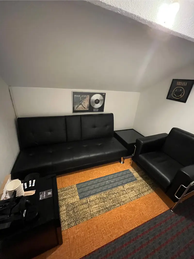Sofa and armchair in the upstairs lounge at Unit 8 Studios
